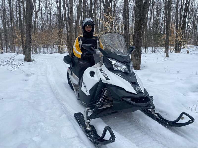 Montreal: Canadian Forest Guided Tour by Snowmobile - Getting suited up at the snowmobile base